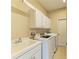 Convenient laundry room with modern washer and dryer, and ample cabinet space at 235 River Enclave Ct, Bradenton, FL 34212