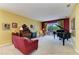Cozy living room boasts a grand piano and views of the outdoor pool and lake at 235 River Enclave Ct, Bradenton, FL 34212