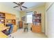 Functional office space with a ceiling fan, built-in desk, and ample storage at 235 River Enclave Ct, Bradenton, FL 34212
