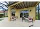 Outdoor patio area with comfortable seating, perfect for entertaining and enjoying the backyard and lake view at 235 River Enclave Ct, Bradenton, FL 34212