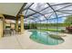 Screened-in pool and spa area with lake views and patio seating at 235 River Enclave Ct, Bradenton, FL 34212
