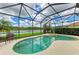 Private pool and spa in screened-in lanai overlooking lush greenery and a tranquil lake at 235 River Enclave Ct, Bradenton, FL 34212