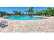 The large community pool features a brick-paved deck and inviting seating under a clear sky at 235 River Enclave Ct, Bradenton, FL 34212