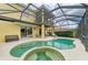 Spacious screened-in patio with a custom-shaped pool and spa at 235 River Enclave Ct, Bradenton, FL 34212