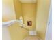 Bright stairway with carpet and a small, arched window providing natural light at 235 River Enclave Ct, Bradenton, FL 34212