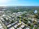 An aerial view of a community with homes, trees, and a river leading to the ocean at 2419 Riverbluff Pkwy # V233, Sarasota, FL 34231