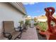 Outdoor patio area with chairs, lush landscaping, a BBQ grill, and a decorative statue at 2419 Riverbluff Pkwy # V233, Sarasota, FL 34231
