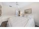 Cozy bedroom with a queen-size bed, soft lighting, a ceiling fan, and a decorative mirror at 2419 Riverbluff Pkwy # V233, Sarasota, FL 34231