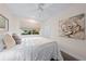 Cozy bedroom featuring a plush bed with decorative pillows and natural light from the window at 2419 Riverbluff Pkwy # V233, Sarasota, FL 34231