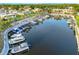 Aerial view of boat dock with multiple boats, and palm trees along the shore, offering a waterfront lifestyle at 2419 Riverbluff Pkwy # V233, Sarasota, FL 34231