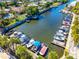An aerial shot of boat docks on the canal, surrounded by lush green foliage and waterfront homes at 2419 Riverbluff Pkwy # V233, Sarasota, FL 34231