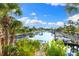 Scenic canal view lined with boat docks and palm trees against a clear sky with scattered clouds at 2419 Riverbluff Pkwy # V233, Sarasota, FL 34231
