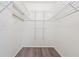 Walk-in closet with adjustable shelving and modern wood-look flooring at 2419 Riverbluff Pkwy # V233, Sarasota, FL 34231