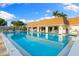 The community pool with poolside seating and a covered area for relaxation in a beautiful outdoor setting at 2419 Riverbluff Pkwy # V233, Sarasota, FL 34231
