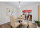 Cozy dining area with glass table near sliding glass doors to an outdoor patio at 2419 Riverbluff Pkwy # V233, Sarasota, FL 34231
