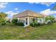 Exterior shot with a screened-in porch and manicured landscaping at 2419 Riverbluff Pkwy # V233, Sarasota, FL 34231