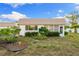 Charming home featuring well-maintained lawn and garden beds at 2419 Riverbluff Pkwy # V233, Sarasota, FL 34231