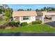Charming home featuring stone accents, lush landscaping, and a well-maintained lawn at 2419 Riverbluff Pkwy # V233, Sarasota, FL 34231