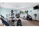 Brightly lit gym with various machines, including weights, cycles, and a stationary fan at 2419 Riverbluff Pkwy # V233, Sarasota, FL 34231