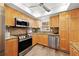 Well-lit kitchen with stainless steel appliances, granite counters, and ample cabinet space at 2419 Riverbluff Pkwy # V233, Sarasota, FL 34231