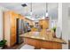 Modern kitchen boasts stainless steel appliances, granite countertops, and stylish pendant lighting at 2419 Riverbluff Pkwy # V233, Sarasota, FL 34231