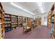 Community library featuring rows of bookshelves and comfortable seating area at 2419 Riverbluff Pkwy # V233, Sarasota, FL 34231