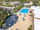 Community pool with sun loungers and umbrellas, set in a brick-paved area at 2419 Riverbluff Pkwy # V233, Sarasota, FL 34231