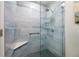 Walk-in shower featuring stylish blue tile, glass enclosure, and modern fixtures at 2419 Riverbluff Pkwy # V233, Sarasota, FL 34231