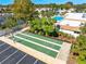 Aerial view of a shuffleboard court, with a pool and surrounding landscaping at 2419 Riverbluff Pkwy # V233, Sarasota, FL 34231