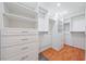 Spacious walk-in closet with built-in shelving, drawers, and ample storage space at 2419 Riverbluff Pkwy # V233, Sarasota, FL 34231