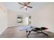 Home gym featuring natural light, equipment, and wood-look floors at 2419 Riverbluff Pkwy # V233, Sarasota, FL 34231