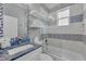 Bright bathroom featuring blue and white mosaic tile, floating shelves, and modern vanity at 2500 Gulf N Dr, Bradenton Beach, FL 34217
