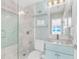 Stylish bathroom with a glass-enclosed shower, floating shelves, and modern fixtures at 2500 Gulf N Dr, Bradenton Beach, FL 34217