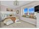 Cozy bedroom featuring a window seat, a decorative ceiling fan, and soothing decor at 2500 Gulf N Dr, Bradenton Beach, FL 34217