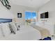 Comfortable bedroom with crisp white bedding and a dresser, offering relaxing space with a view at 2500 Gulf N Dr, Bradenton Beach, FL 34217