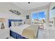 Comfortable bedroom with crisp white bedding and a dresser, offering relaxing space with a view at 2500 Gulf N Dr, Bradenton Beach, FL 34217