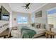 Bright bedroom with beach view, coastal decor, and white wood flooring creating a relaxing ambiance at 2500 Gulf N Dr, Bradenton Beach, FL 34217