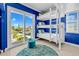 Bright bunk room featuring a balcony with beach views and triple bunk beds for ample sleeping space at 2500 Gulf N Dr, Bradenton Beach, FL 34217