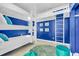 Blue-themed bunk room with triple bunk beds, cozy decor, and beach-themed artwork, perfect for  at 2500 Gulf N Dr, Bradenton Beach, FL 34217