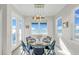 Dining area with seating for six, ocean views, and bright lighting at 2500 Gulf N Dr, Bradenton Beach, FL 34217
