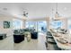 Bright, open floor plan living area with beach views, hardwood floors, and modern furniture at 2500 Gulf N Dr, Bradenton Beach, FL 34217