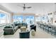 Bright living room with ocean view, sectional couch, and adjacent kitchen at 2500 Gulf N Dr, Bradenton Beach, FL 34217