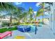 Backyard oasis featuring a swimming pool, a hot tub, ample seating, and lush tropical landscaping at 2500 Gulf N Dr, Bradenton Beach, FL 34217