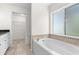 Soaking tub next to a window and next to a walk-in closet at 2575 Johannesberg Rd, North Port, FL 34288