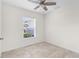 Neutral bedroom with fan, tile floors and a window providing natural light at 2575 Johannesberg Rd, North Port, FL 34288
