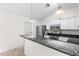 Kitchen with stainless steel appliances, granite countertops, white cabinetry and pendant lights at 2575 Johannesberg Rd, North Port, FL 34288