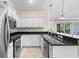 Kitchen features stainless steel appliances, granite countertops, and lots of cabinets at 2575 Johannesberg Rd, North Port, FL 34288