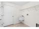 Bright laundry room with white walls, tile floor, sink, and storage shelves at 2575 Johannesberg Rd, North Port, FL 34288
