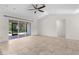 Spacious living area with tile floors and sliding doors leading to the screened patio at 2575 Johannesberg Rd, North Port, FL 34288