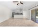 Bright and spacious living room with tile floors, ceiling fan, and open access to the kitchen at 2575 Johannesberg Rd, North Port, FL 34288